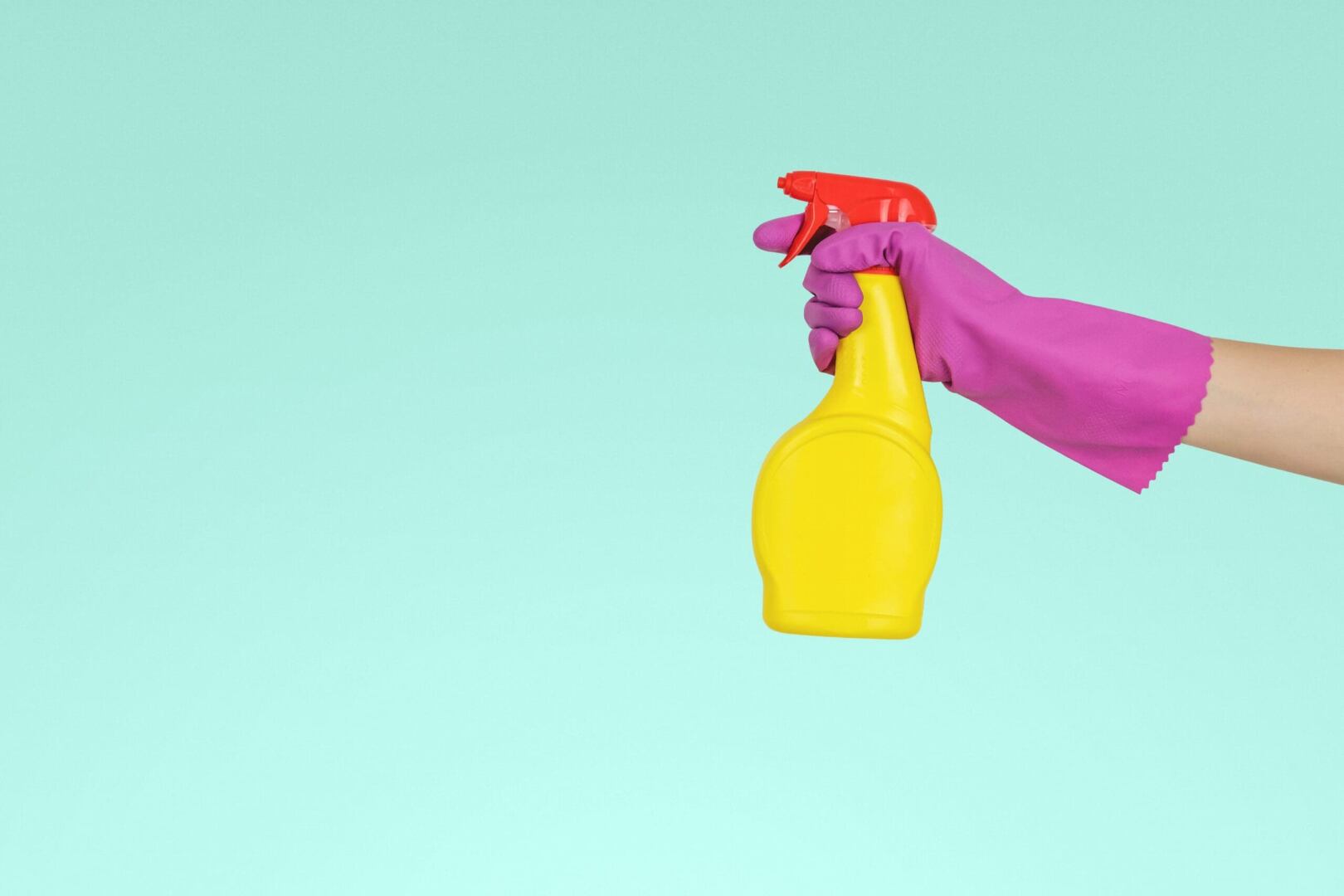 glove hand and cleaning spray bottle